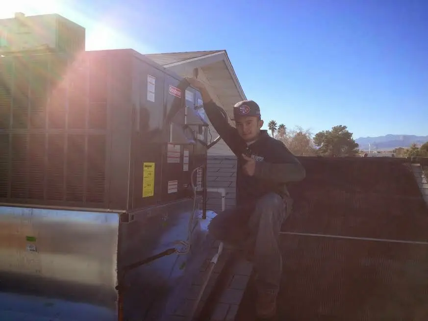 HVAC technician performing HVAC Inspection on a rooftop unit in Wheat Ridge